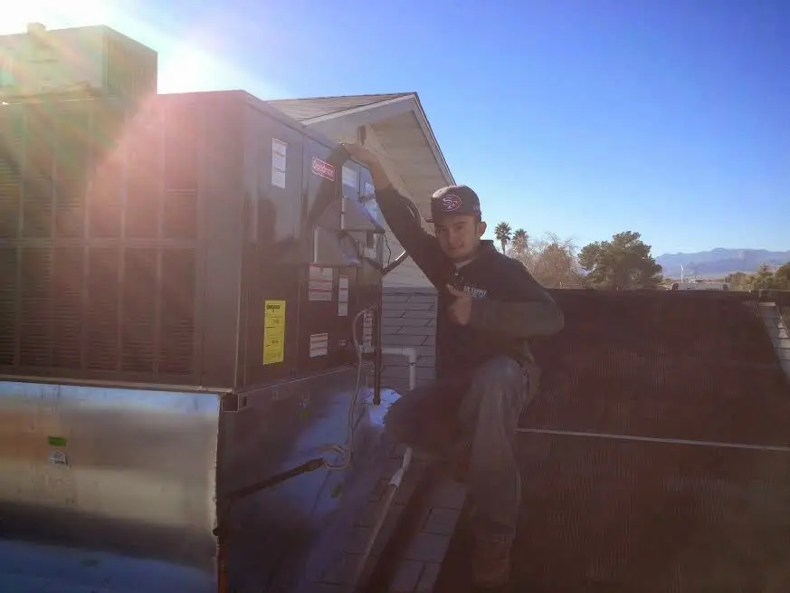 HVAC technician performing Air Duct Cleaning on a rooftop unit in Hatfield